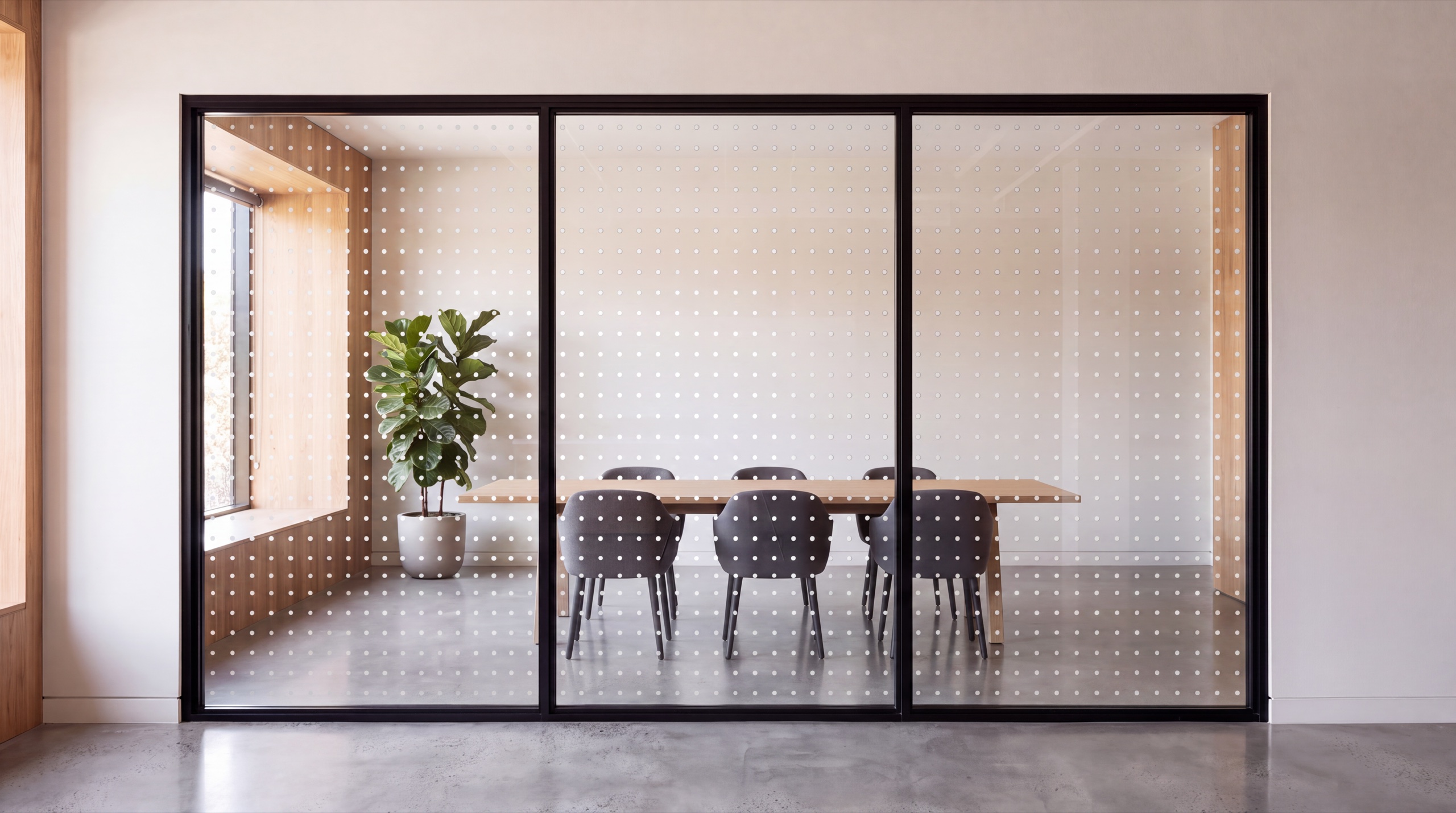 The same partition with an evenly spaced grid of small frosted dots across the glass, the room partly visible between them